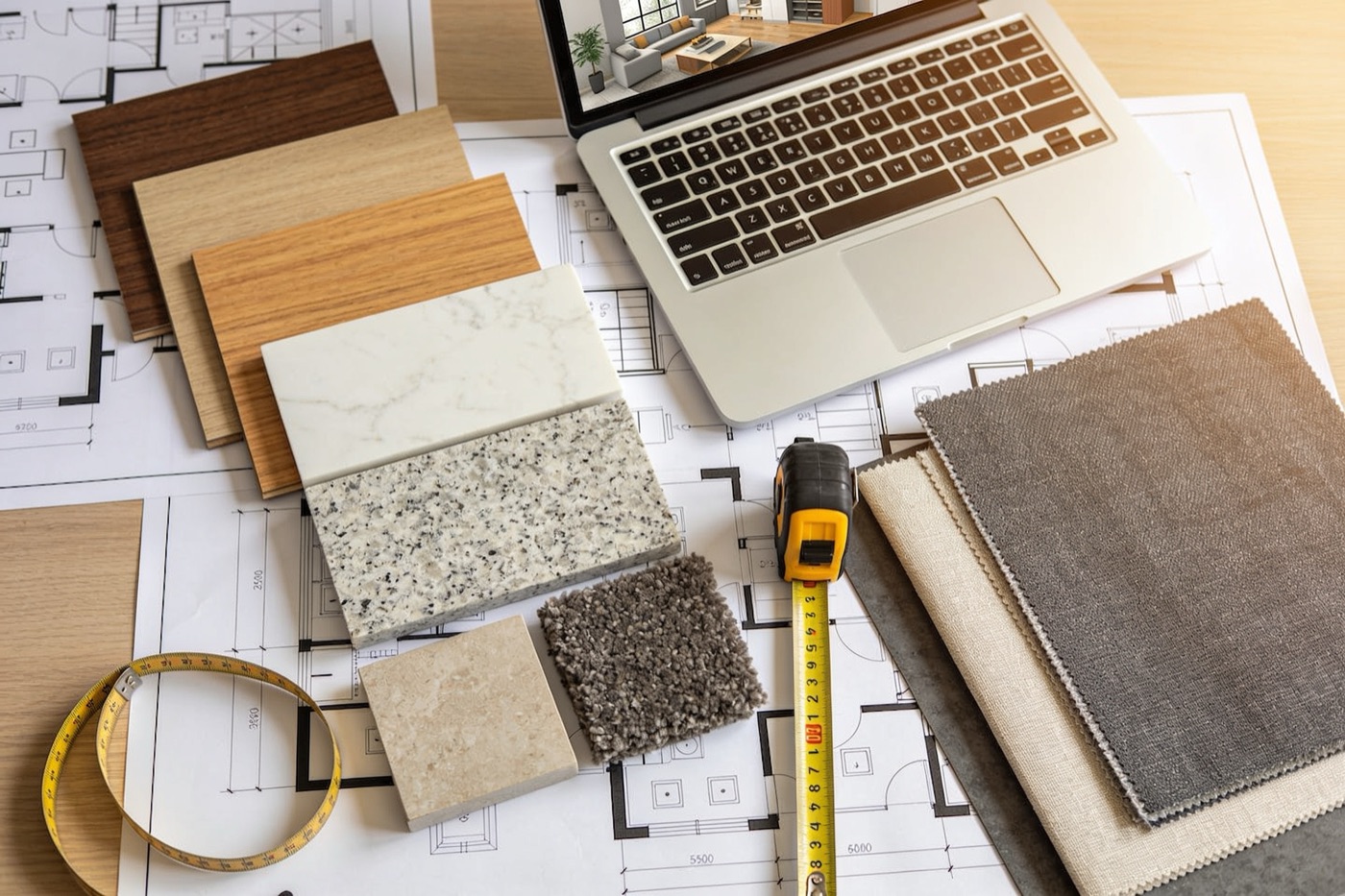 Interior design planning desk with floor plans and samples