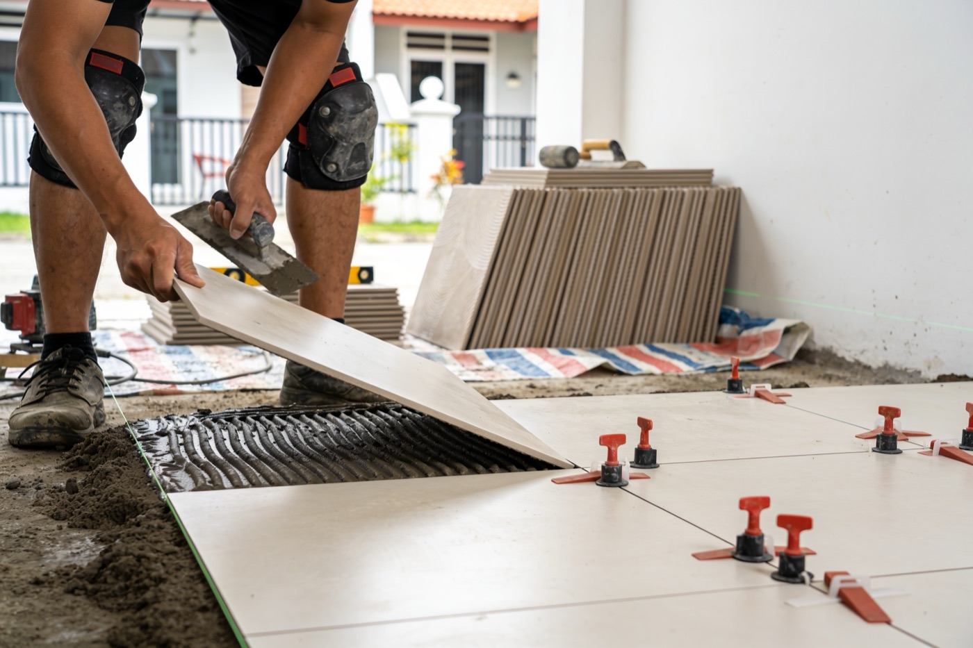 Tiler laying floor tiles